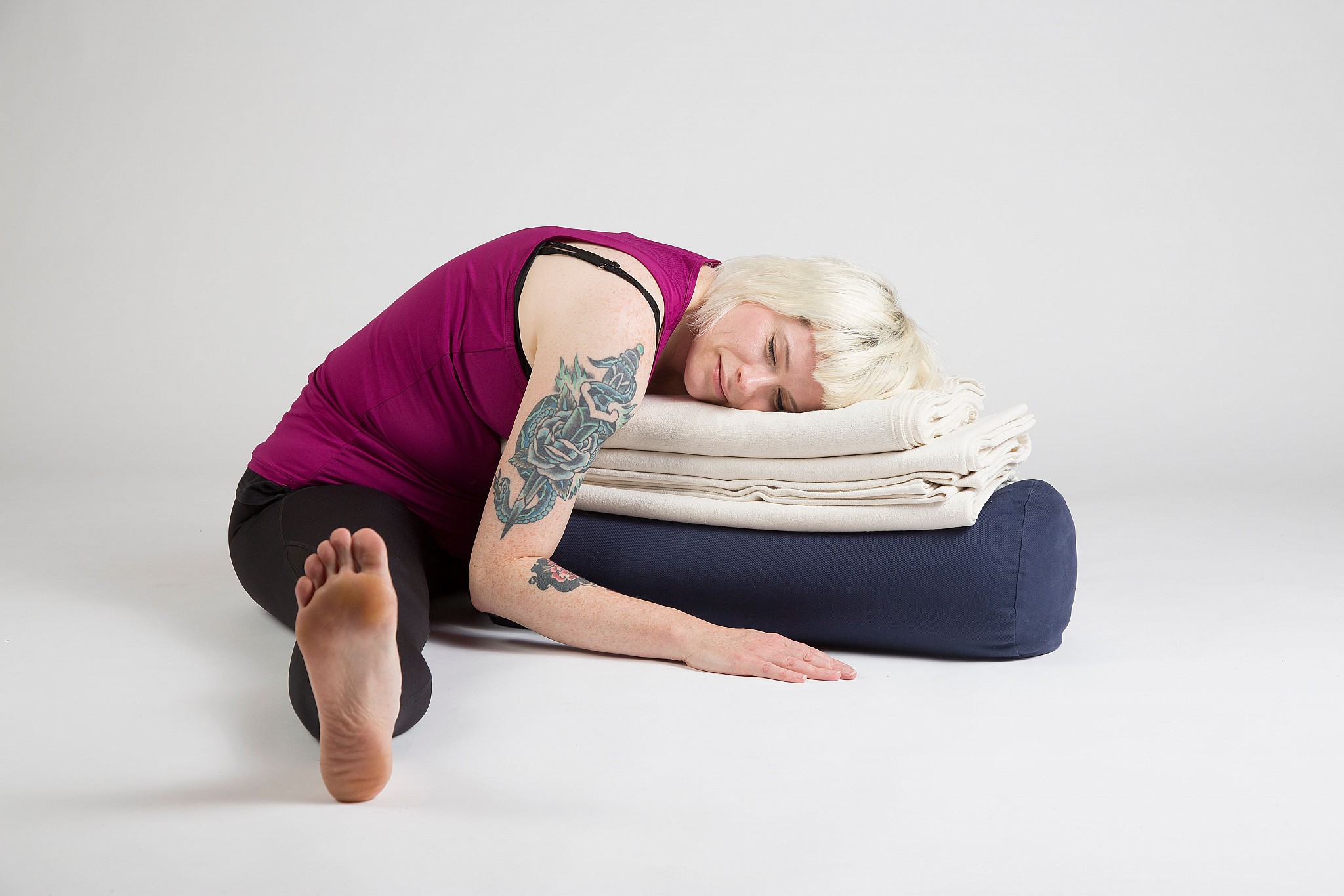 Yoga student in restorative forward fold